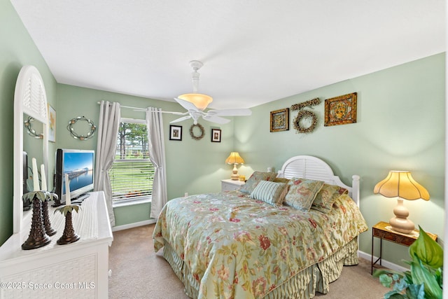 bedroom featuring light colored carpet and baseboards