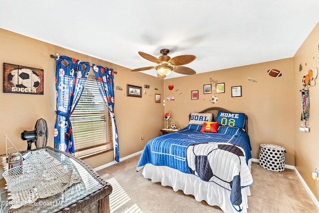 bedroom with a ceiling fan, light carpet, and baseboards