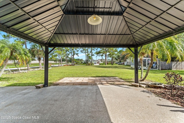 view of parking / parking lot with a gazebo and fence