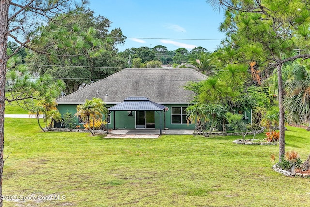 back of property featuring roof with shingles, a gazebo, a yard, a patio area, and stucco siding