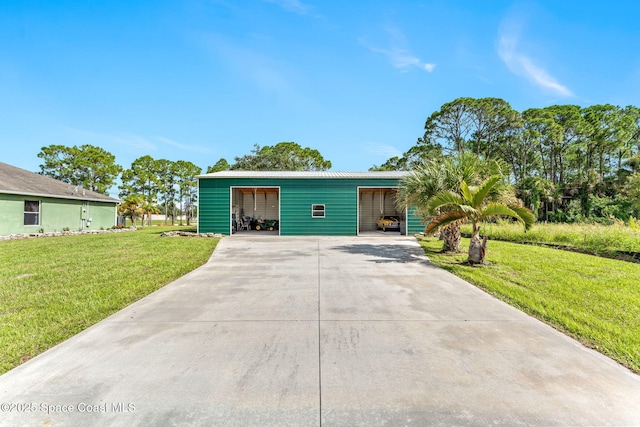 view of front of home with driveway, a garage, and a front yard