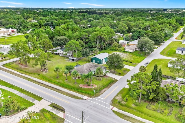 birds eye view of property with a forest view