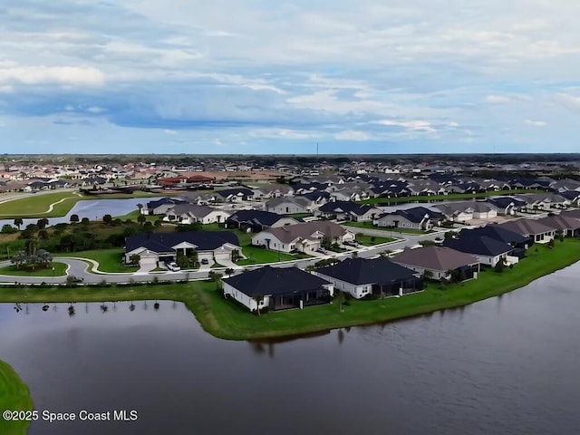 birds eye view of property with a residential view and a water view