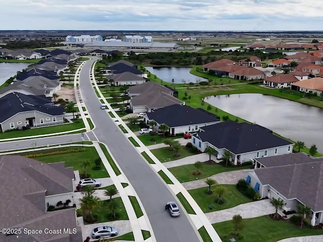 bird's eye view featuring a residential view and a water view