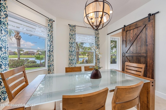 dining area featuring a barn door and a notable chandelier