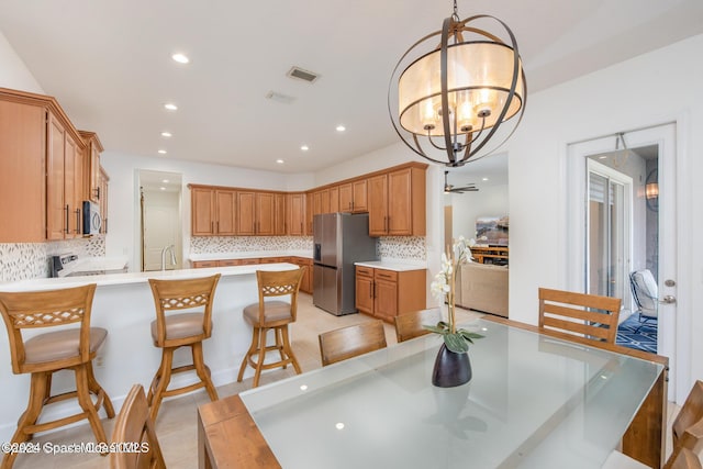 dining room with an inviting chandelier, visible vents, and recessed lighting