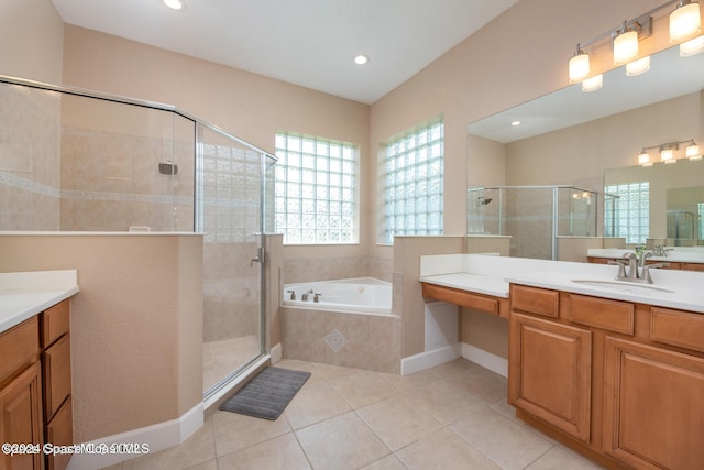 full bath featuring a stall shower, tile patterned flooring, a bath, and vanity