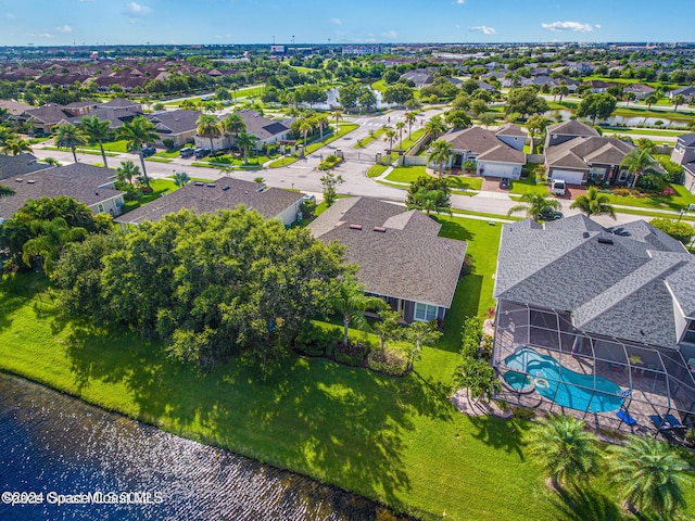 drone / aerial view with a water view and a residential view