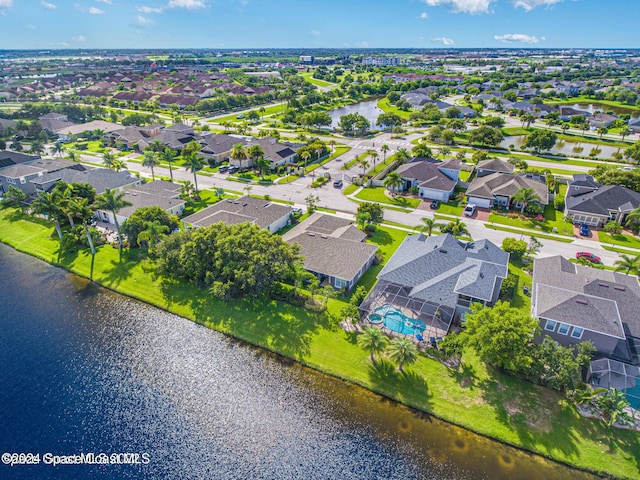 drone / aerial view featuring a water view and a residential view