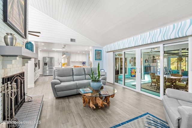 living room with light wood-style floors, high vaulted ceiling, ceiling fan, visible vents, and wood ceiling