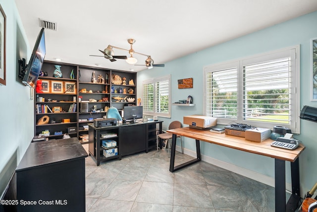 home office featuring light tile patterned floors, visible vents, and ceiling fan