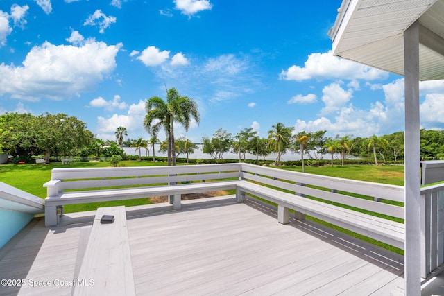 wooden deck featuring a yard