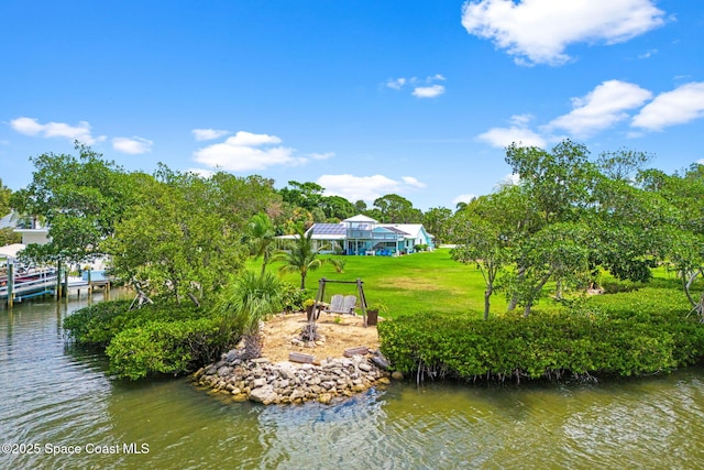view of dock with a water view and a lawn