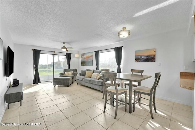 living room with a healthy amount of sunlight, a textured ceiling, and light tile patterned flooring