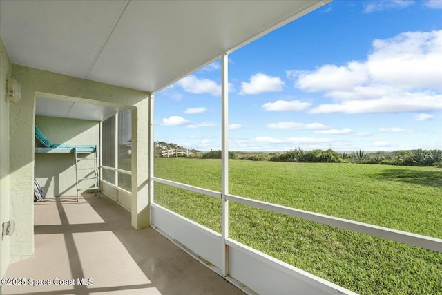 sunroom featuring a rural view