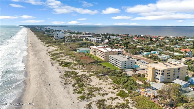 bird's eye view with a city view, a water view, and a beach view