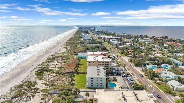 bird's eye view featuring a water view and a beach view