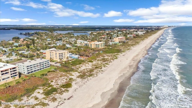 bird's eye view with a water view and a beach view