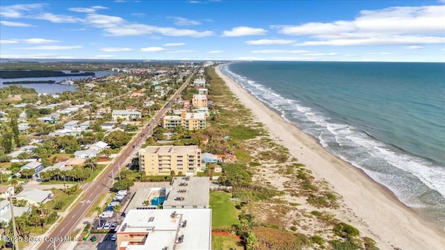 drone / aerial view featuring a beach view and a water view