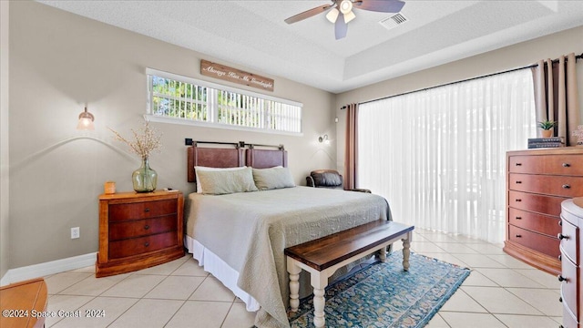 bedroom with light tile patterned floors, visible vents, baseboards, access to outside, and a textured ceiling