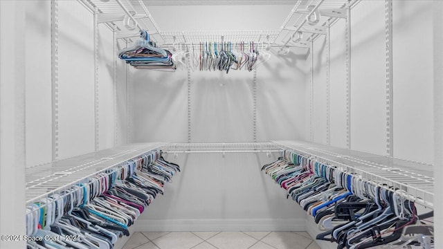 walk in closet with tile patterned flooring