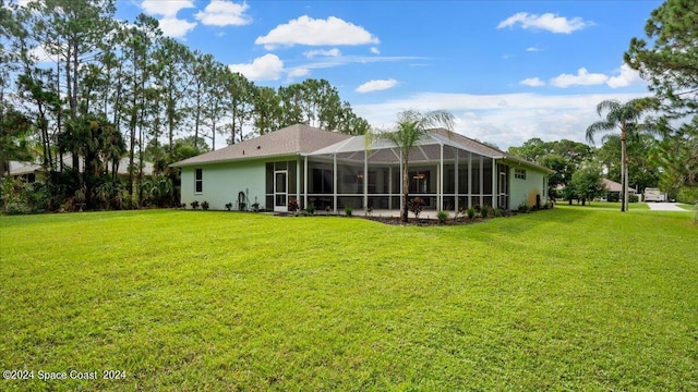 back of house featuring glass enclosure, a lawn, and stucco siding