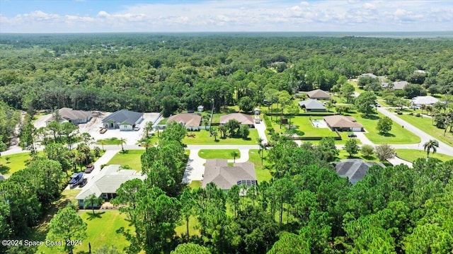 drone / aerial view with a forest view and a residential view