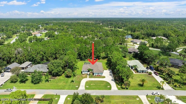 birds eye view of property featuring a residential view and a forest view