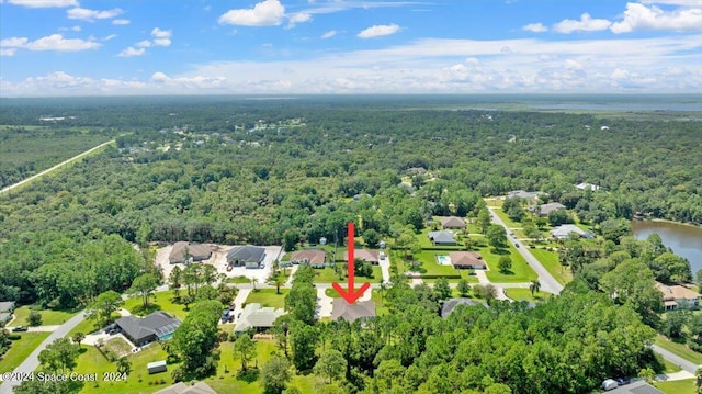 birds eye view of property with a water view, a residential view, and a view of trees