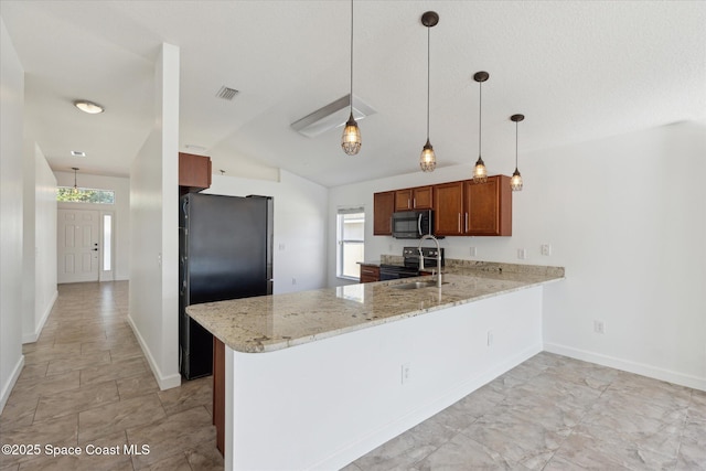 kitchen featuring a peninsula, appliances with stainless steel finishes, a sink, and visible vents