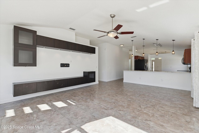 unfurnished living room featuring visible vents, vaulted ceiling, baseboards, and ceiling fan