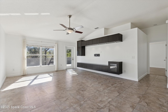 unfurnished living room featuring lofted ceiling, baseboards, visible vents, and a ceiling fan