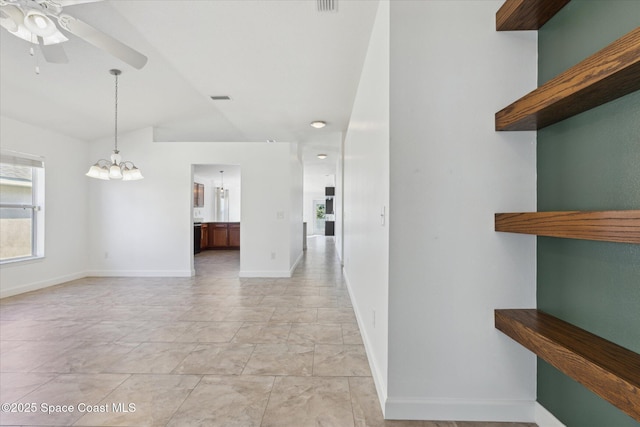 interior space with lofted ceiling, an inviting chandelier, visible vents, and baseboards