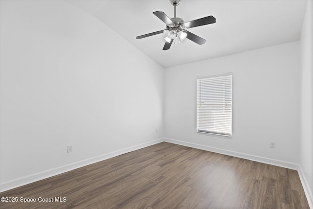 spare room with lofted ceiling, ceiling fan, baseboards, and wood finished floors