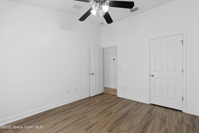 unfurnished bedroom with dark wood-style floors, ceiling fan, visible vents, and baseboards