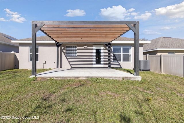 back of house featuring a fenced backyard, a yard, stucco siding, a pergola, and a patio area