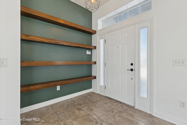 entryway featuring baseboards