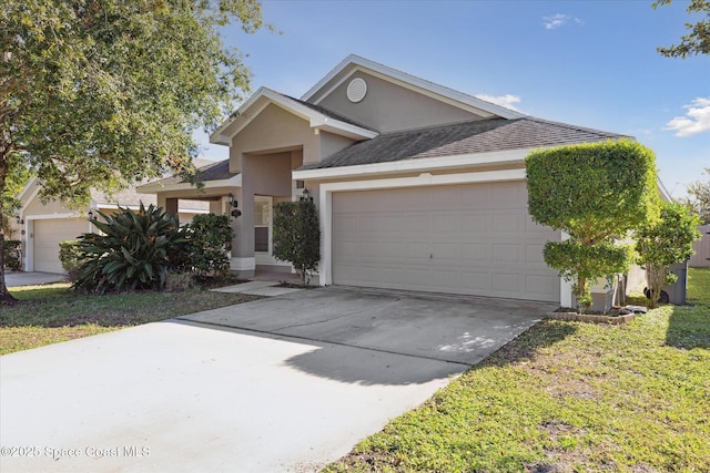 single story home with a garage, driveway, roof with shingles, stucco siding, and a front yard