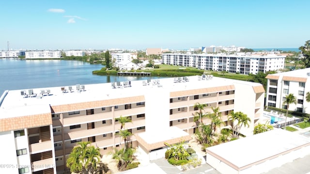 drone / aerial view featuring a city view and a water view