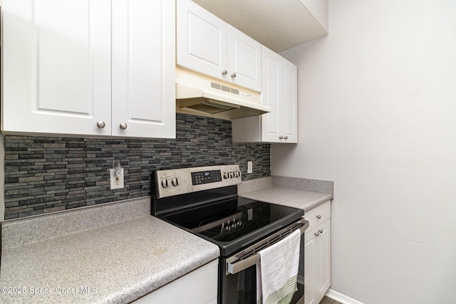 kitchen with white cabinets, stainless steel electric stove, light countertops, under cabinet range hood, and backsplash