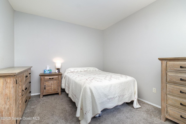 bedroom with light carpet and baseboards