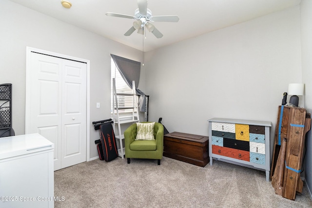 living area featuring carpet floors and a ceiling fan