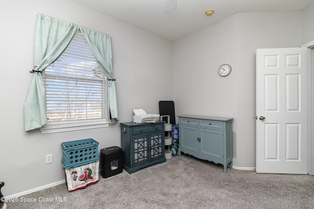 carpeted home office featuring lofted ceiling and baseboards