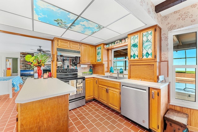 kitchen featuring a sink, stainless steel appliances, light countertops, and under cabinet range hood