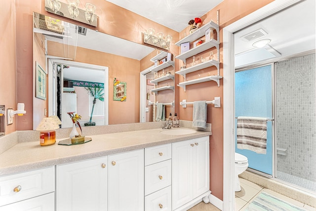 bathroom featuring visible vents, toilet, a shower stall, vanity, and tile patterned floors