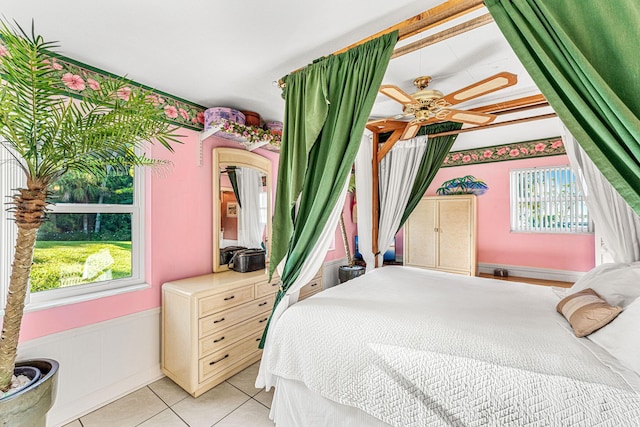 bedroom with multiple windows and light tile patterned flooring