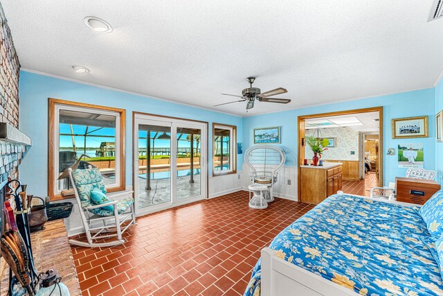 bedroom featuring brick floor, access to exterior, visible vents, ornamental molding, and ceiling fan