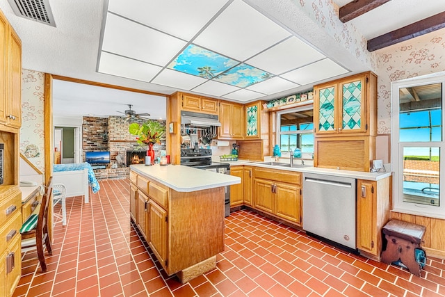 kitchen featuring electric range oven, under cabinet range hood, light countertops, dishwasher, and wallpapered walls