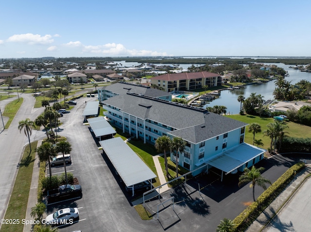 birds eye view of property featuring a water view and a residential view