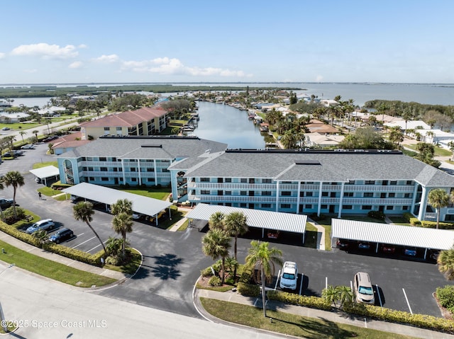 birds eye view of property with a water view